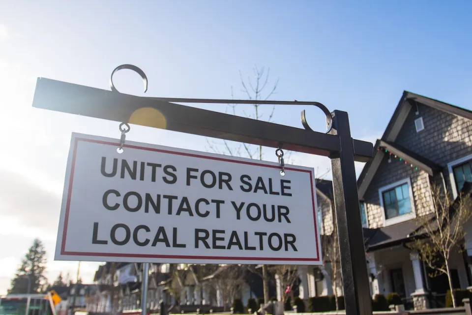 "Units for sale - contact your local realtor" sign in front of homes.